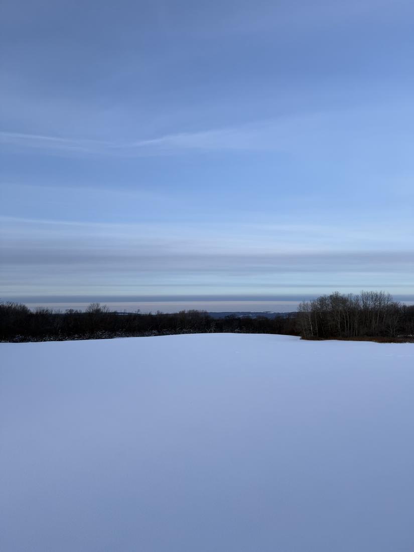 Snow-covered field looking out over the hills